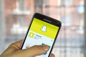 realtor using snapchat on smartphone