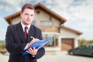 real estate professional in front of house