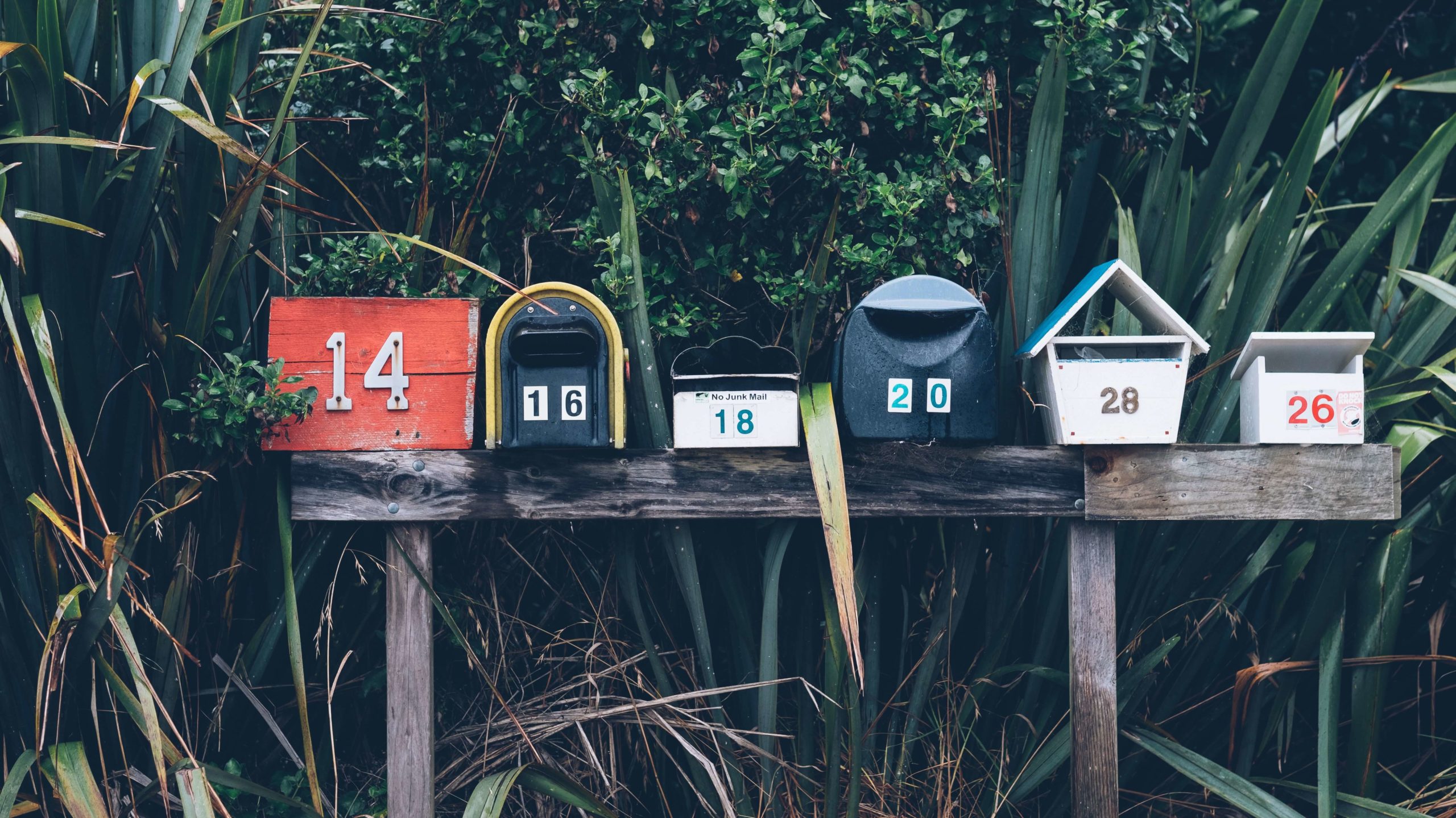 a row of vintage mailboxes, lined up to receive your newsletter to your geo farm